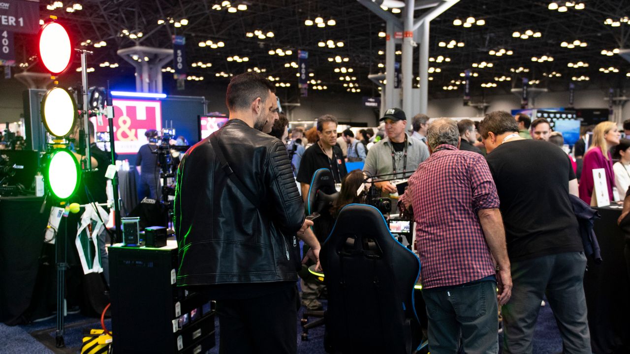 NAB New York Show's floor is packed with people interacting with exhibitors.